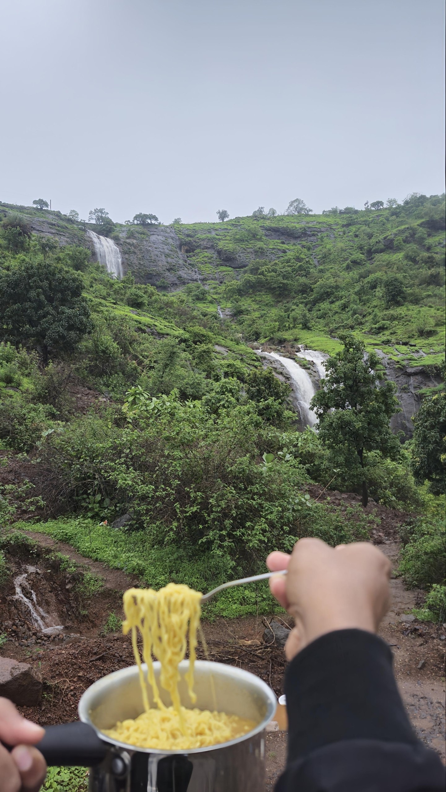 Hot maggi cooked on the trail with the hidden Kanhe–Khandi waterfall in the frame — the best monsoon breakfast spot of the season.